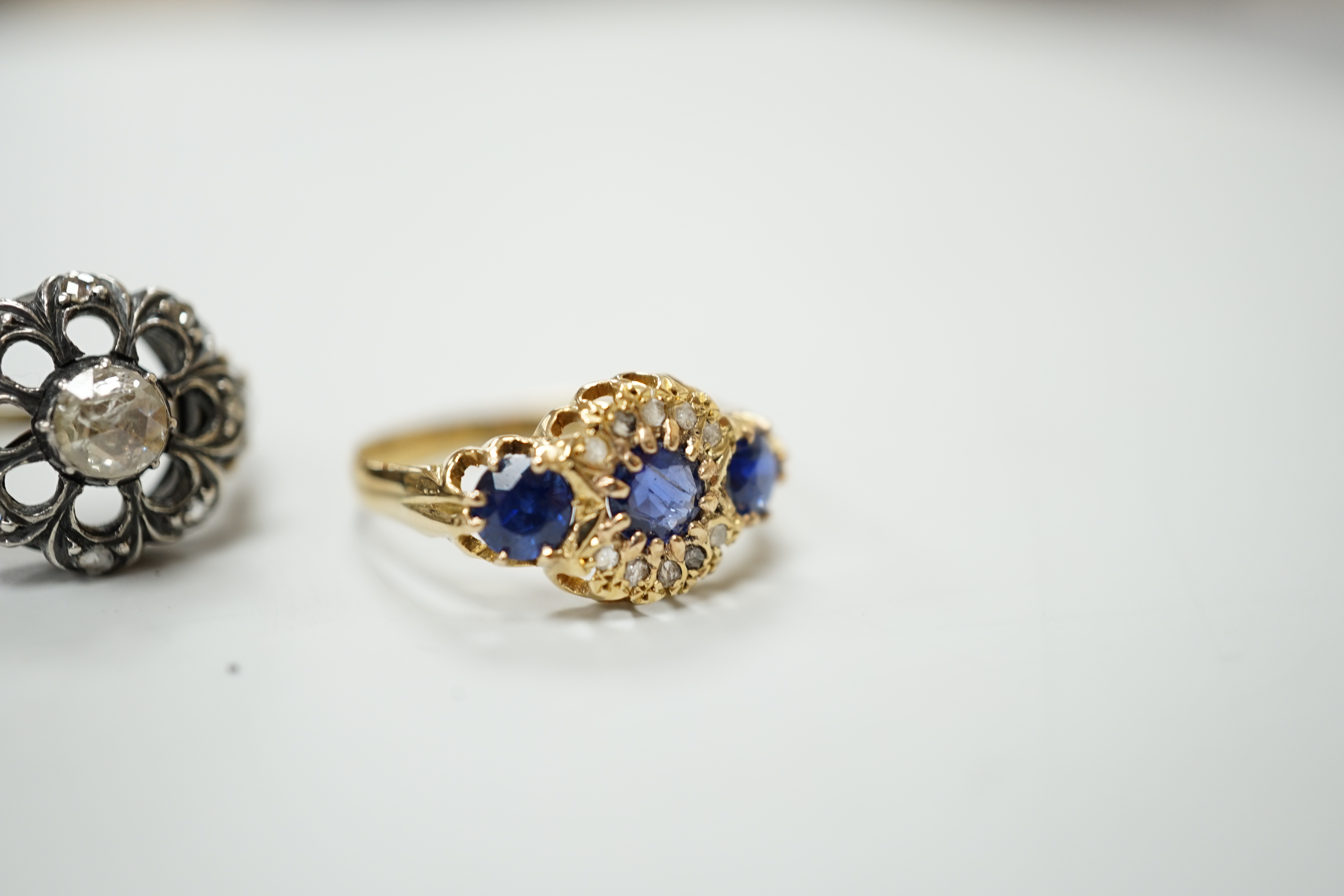 An 18ct gold sapphire and diamond dress ring, size R, gross 2.8 grams and a 19th century rose diamond set ring, size L, gross 5.5 grams
